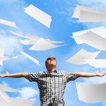 Businessman throwing paperwork