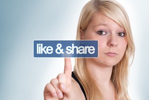 young blonde woman pressing a like and share button