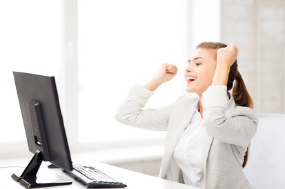 picture of happy businesswoman with computer in office; celebrate; success; victory