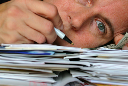 Closeup of person laying on a pile of letters and bills
