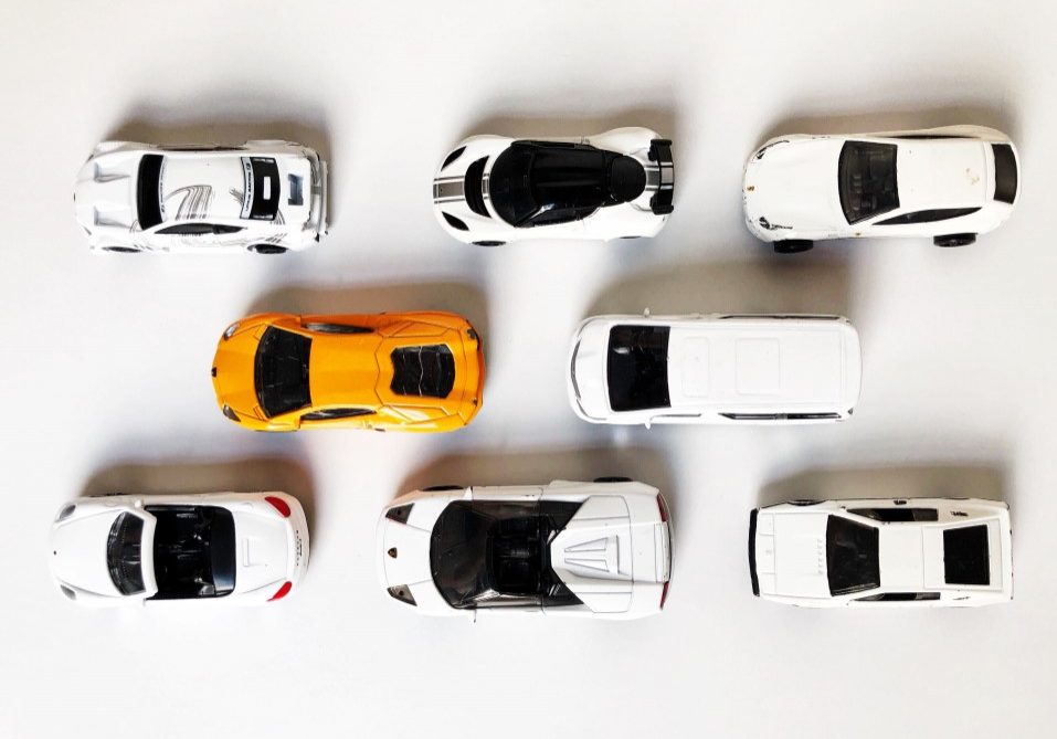 an-orange-toy-car-among-white-toy-cars-conceptual-theme-diversity-dare-to-be-different-be-unique-be_t20_moBVYr